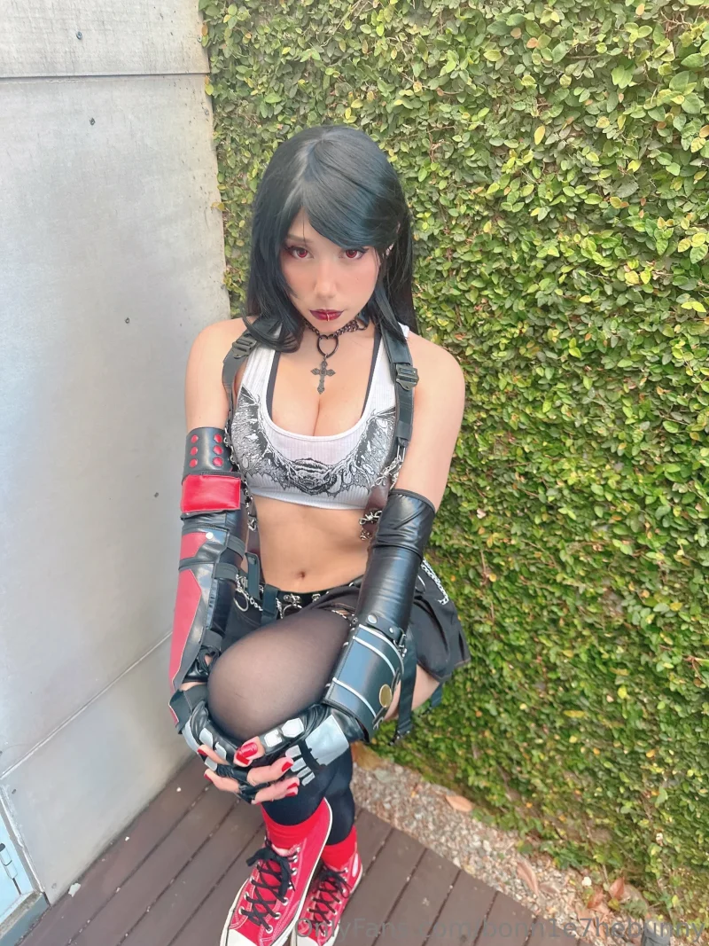 Hot bonn1e7hebunny in cosplay gear, crouching by a hedge with red sneakers and fingerless gloves